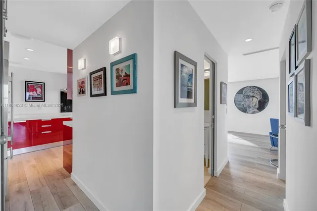 a view of a hallway with wooden floor
