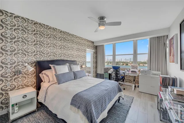 a bedroom with a large bed and a large window