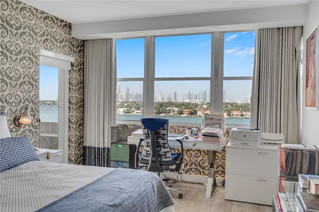 a bedroom with furniture and large windows