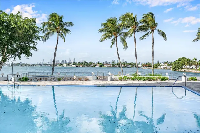 a view of lake with a table and chairs