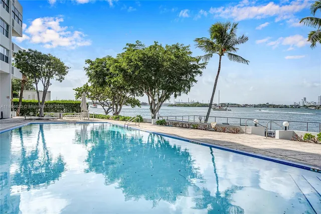 a view of a swimming pool with a table and chairs