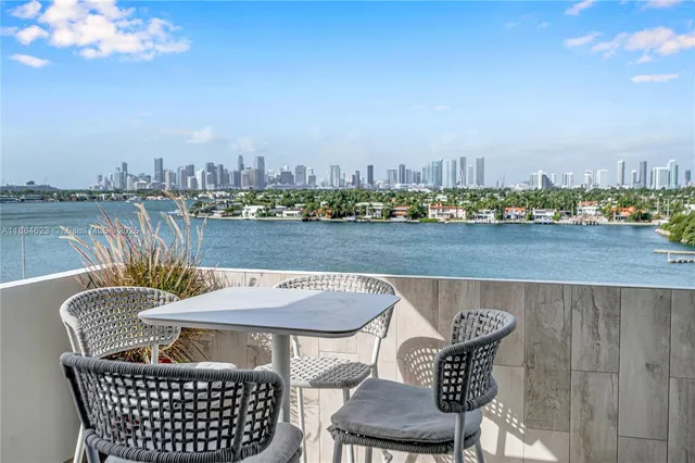 a view of a terrace with furniture and city view
