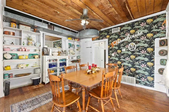 a dining room with furniture and a rug