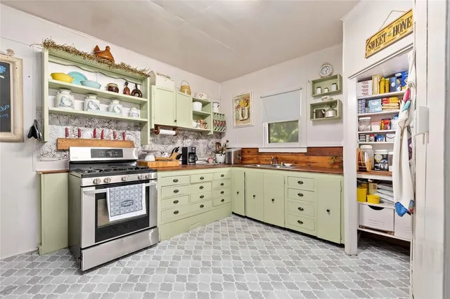 a kitchen with stainless steel appliances a stove and a cabinets