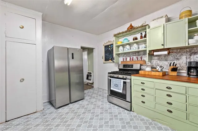 a kitchen with stainless steel appliances granite countertop a refrigerator and a stove