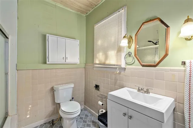 a bathroom with a sink mirror and toilet