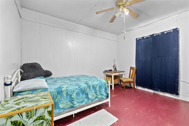 a bedroom with furniture and a window