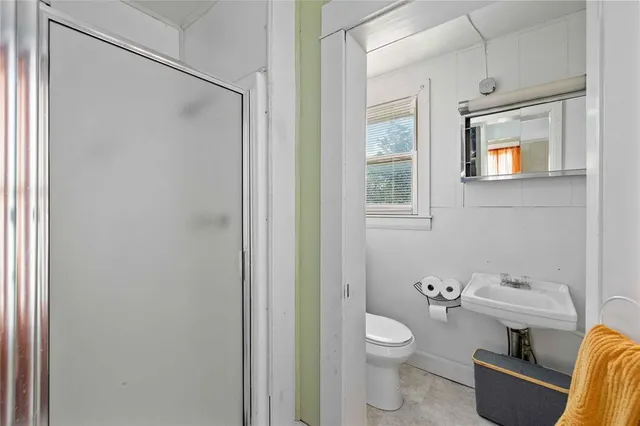 a bathroom with a toilet a sink and a mirror