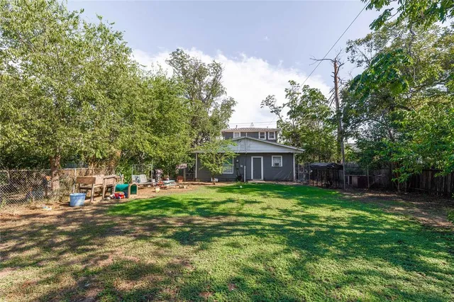 a view of a house with a yard and sitting area