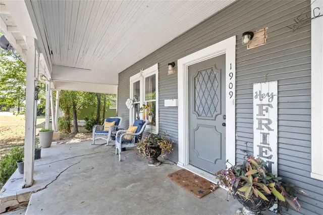 a view of a room with furniture and floor to ceiling window