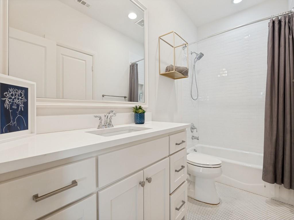 732 West 7th Street Dallas, TX 75208 - Photo 20 of 25 White vanity with an integrated sink, polished chrome faucet, and a quartz-finish countertop