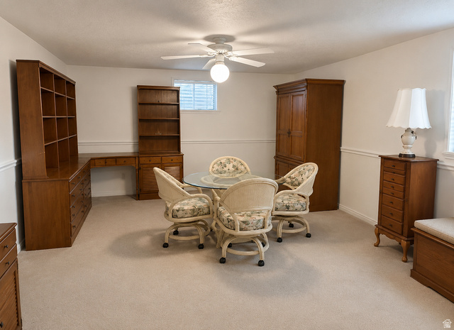 1020 Wilmar Place Centerville, UT 84014 - Photo 13 of 22 Carpeted room featuring a ceiling fan, a built-in desk with shelving, and a small window with blinds