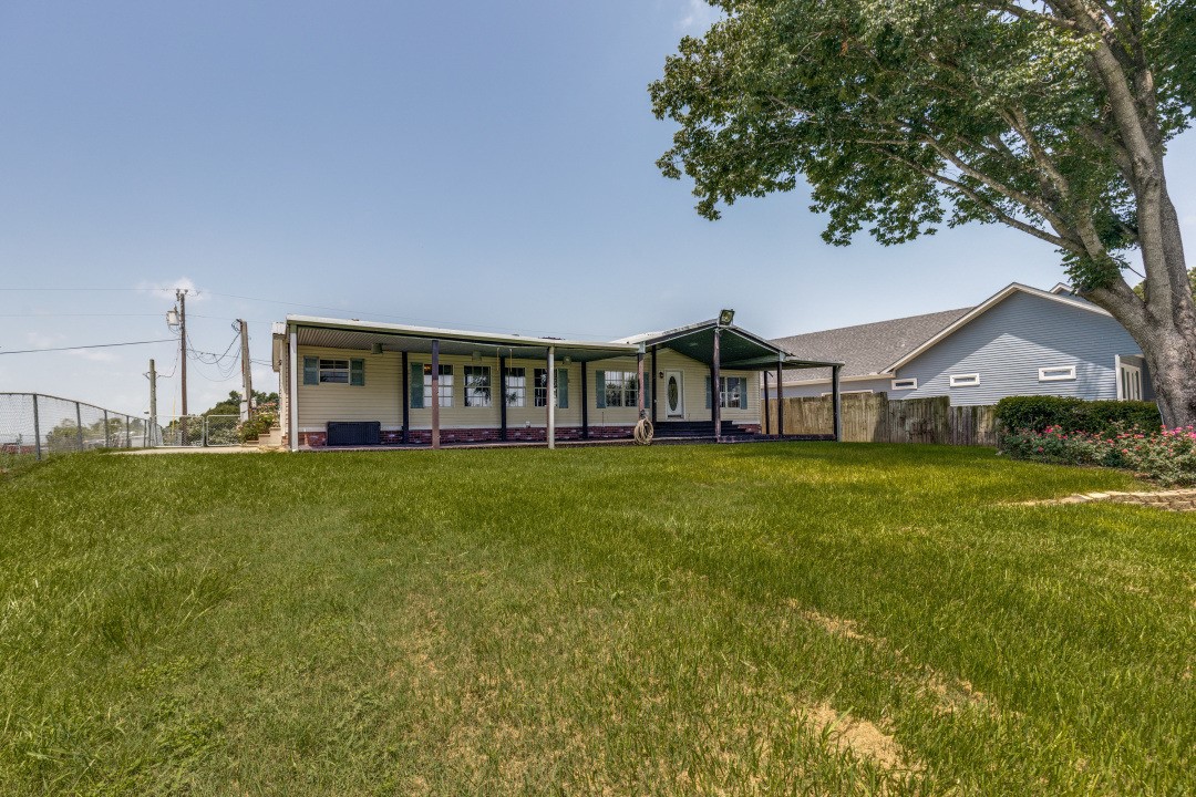 207 Vivian Road Onalaska, TX 77360 - Photo 5 of 34 a view of a house with a big yard
