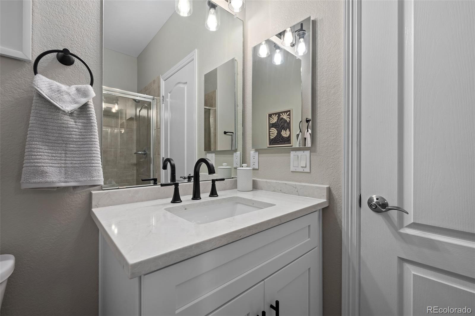 11036 Glengate Circle Highlands Ranch, CO 80130 - Photo 14 of 42 a bathroom with a sink vanity and a mirror