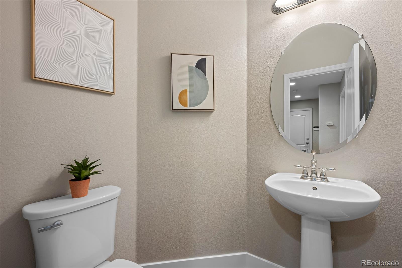11036 Glengate Circle Highlands Ranch, CO 80130 - Photo 15 of 42 a bathroom with a toilet sink and mirror