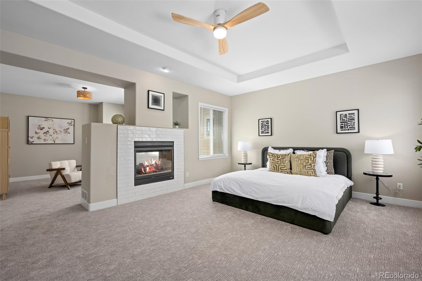 11036 Glengate Circle Highlands Ranch, CO 80130 - Photo 17 of 42 a spacious bedroom with a bed and a chandelier