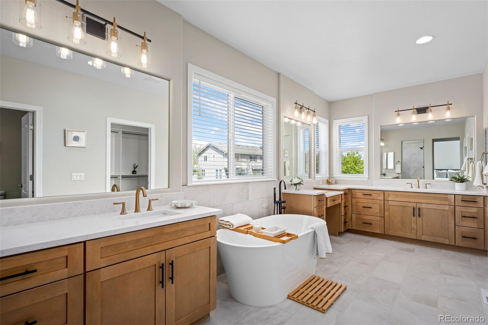 11036 Glengate Circle Highlands Ranch, CO 80130 - Photo 20 of 42 a bathroom with a granite countertop tub sink toilet double vanity and window