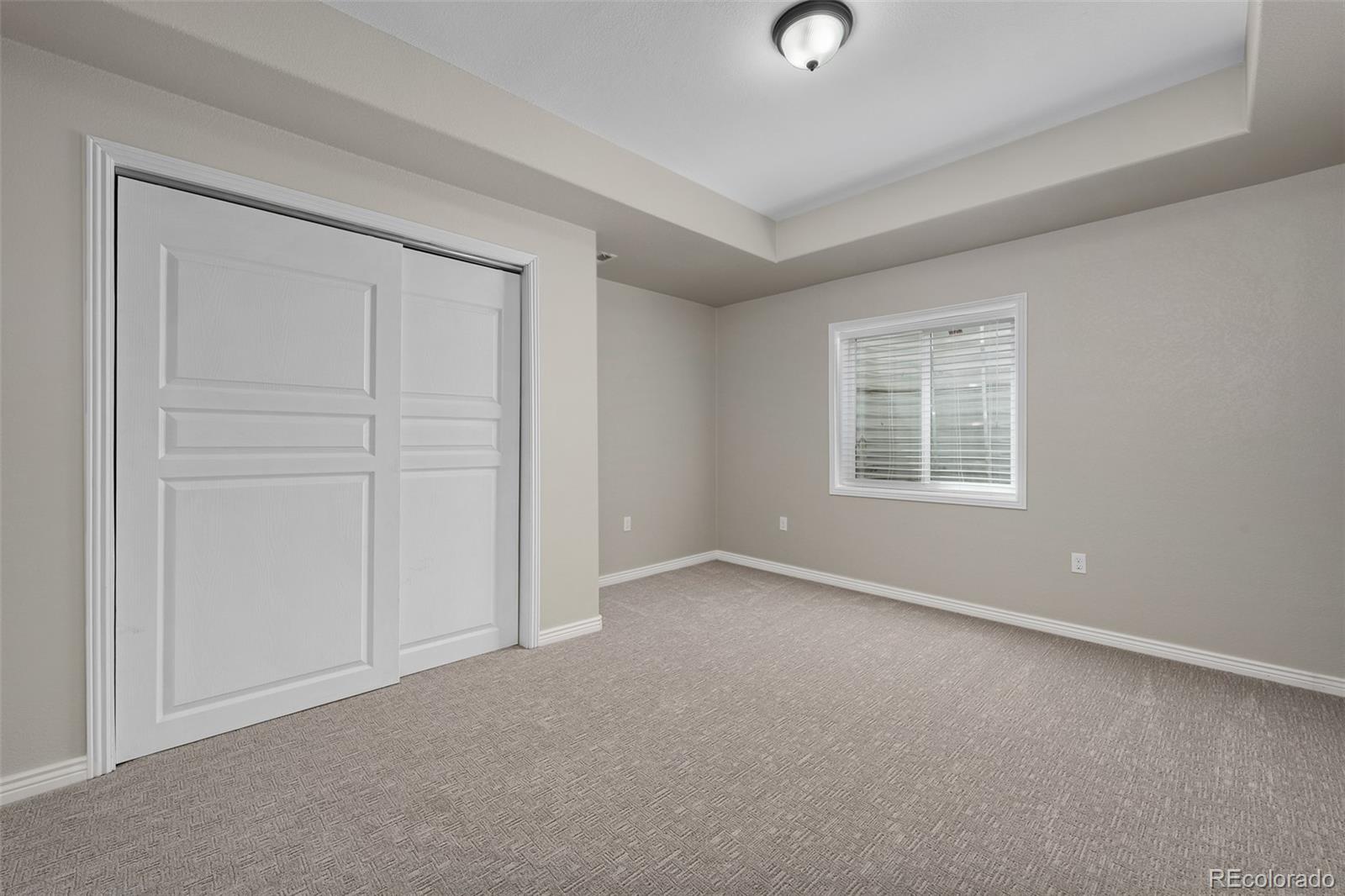 11036 Glengate Circle Highlands Ranch, CO 80130 - Photo 29 of 42 an empty room with windows