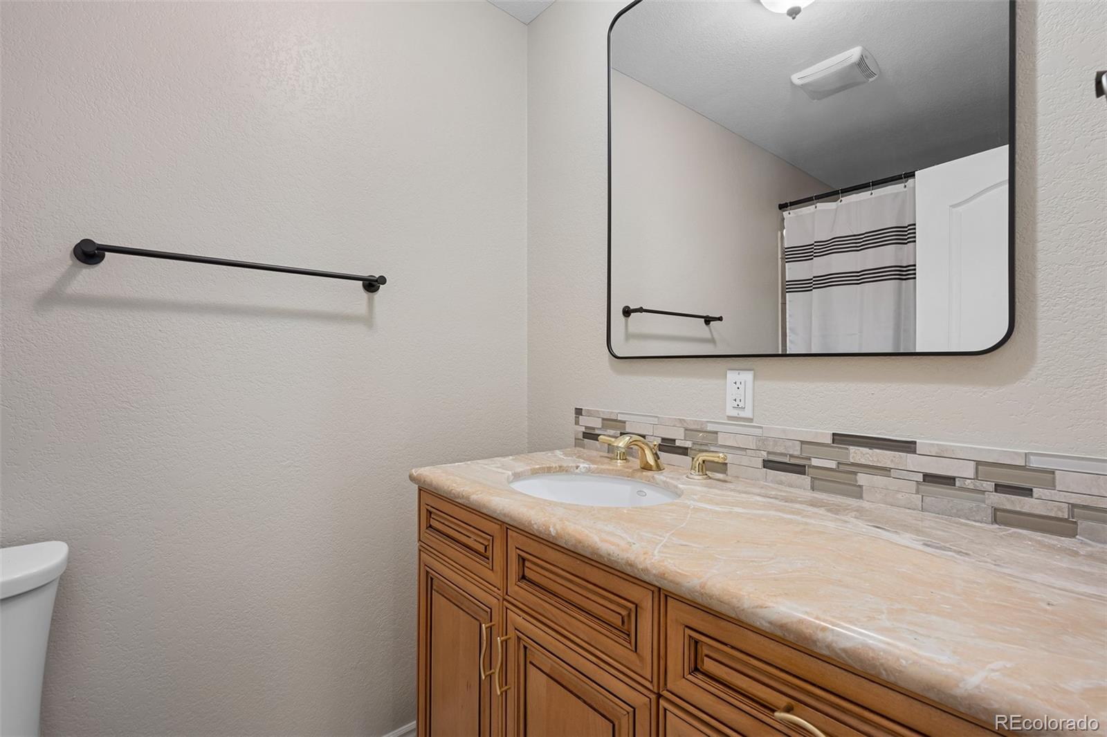 11036 Glengate Circle Highlands Ranch, CO 80130 - Photo 31 of 42 a bathroom with a sink and a mirror