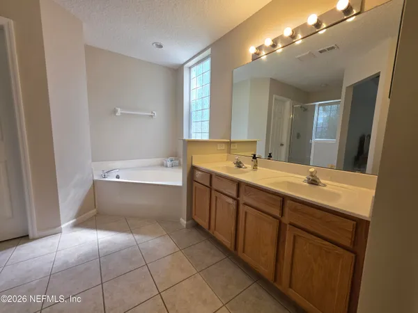 a bathroom with a double vanity sink and mirror