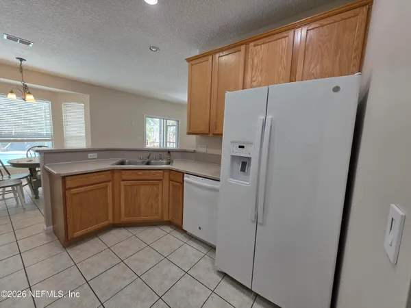 a kitchen with white cabinets a sink and a stove