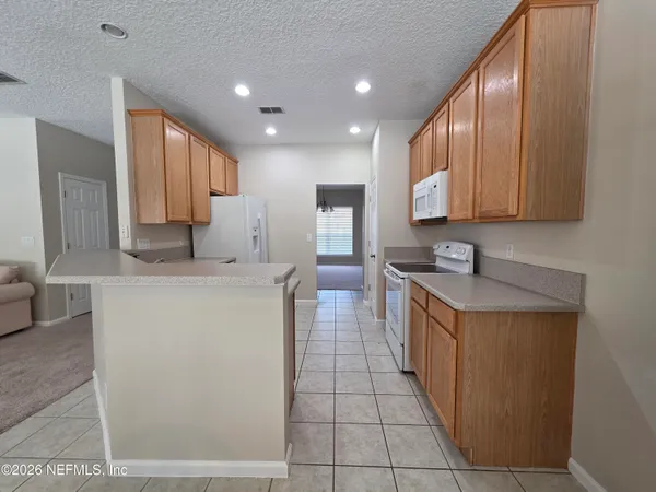 a view of a windows and chandelier in an empty room