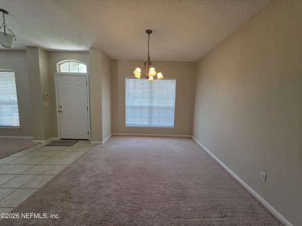 a living room with furniture and a ceiling fan