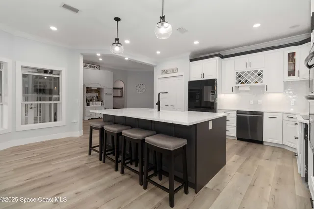 a kitchen with white cabinets and appliances