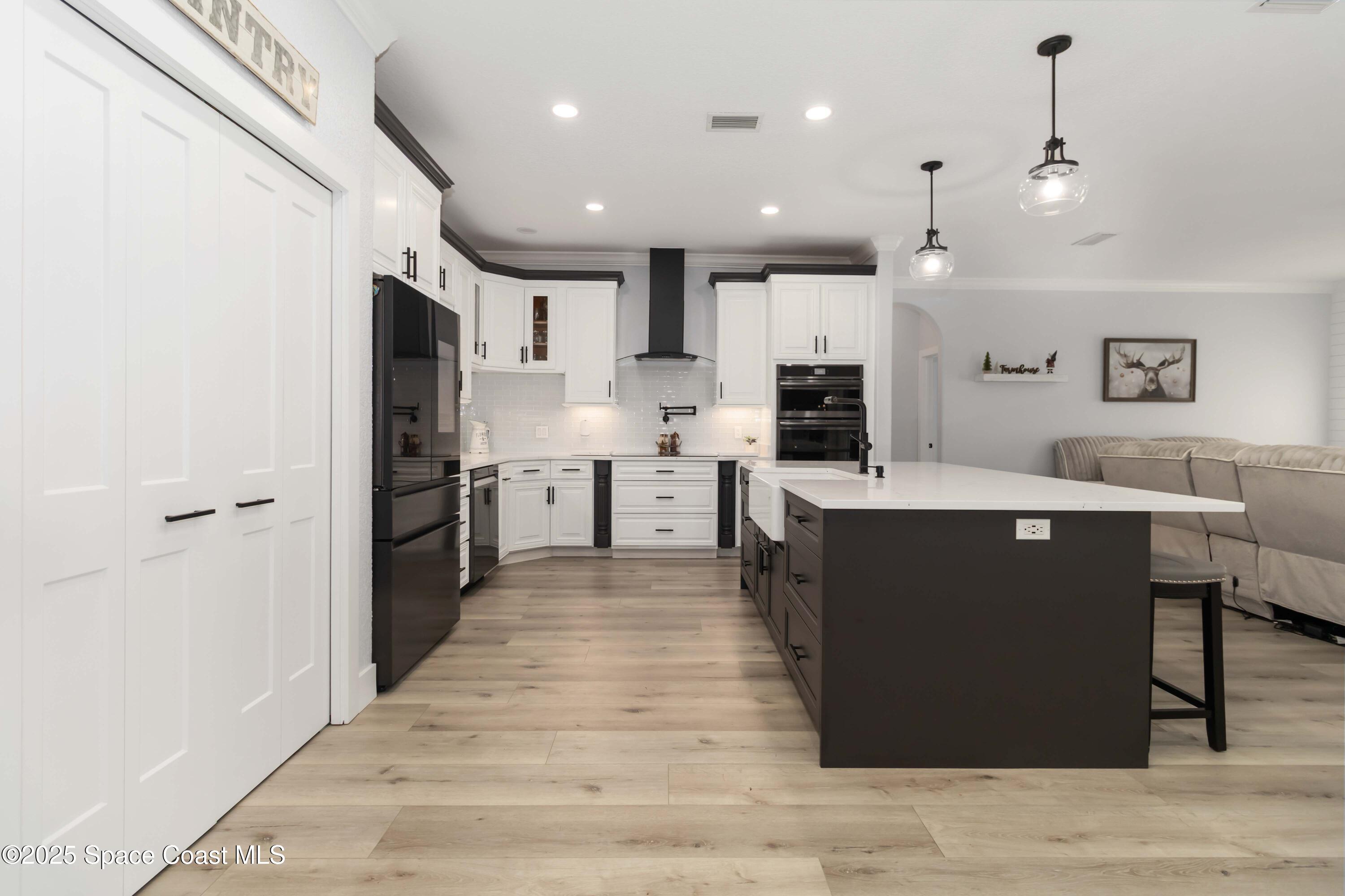 341 Buckskin Street Palm Bay, FL 32909 - Photo 21 of 69 a large kitchen with a large counter top a sink stainless steel appliances and cabinets