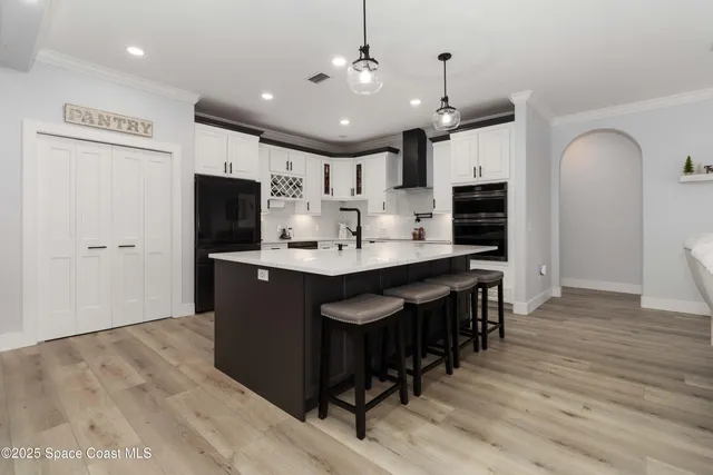 a living room with furniture and kitchen view