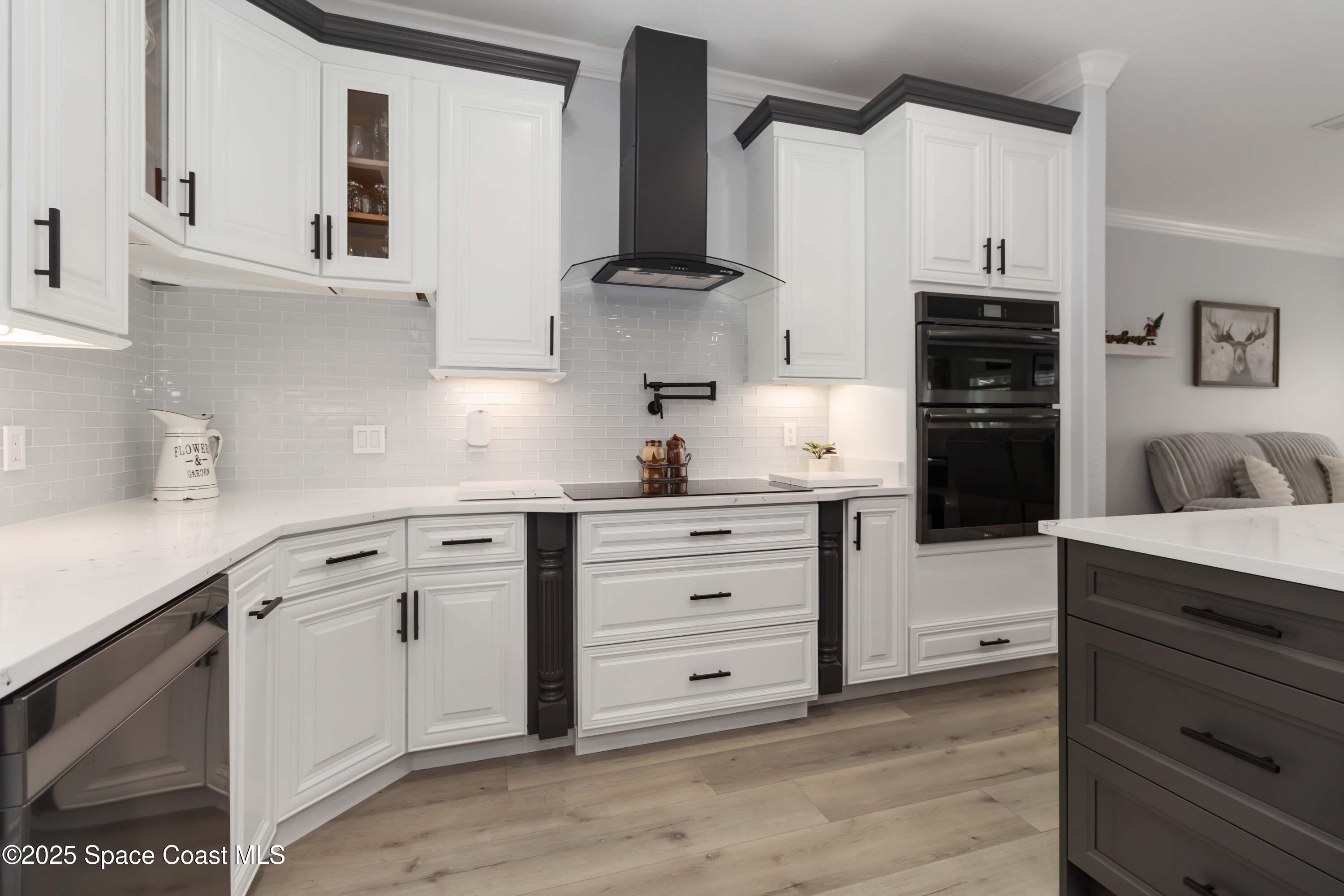 341 Buckskin Street Palm Bay, FL 32909 - Photo 23 of 69 a kitchen with white cabinets and appliances