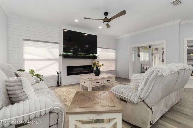 a living room with furniture a rug and a projector