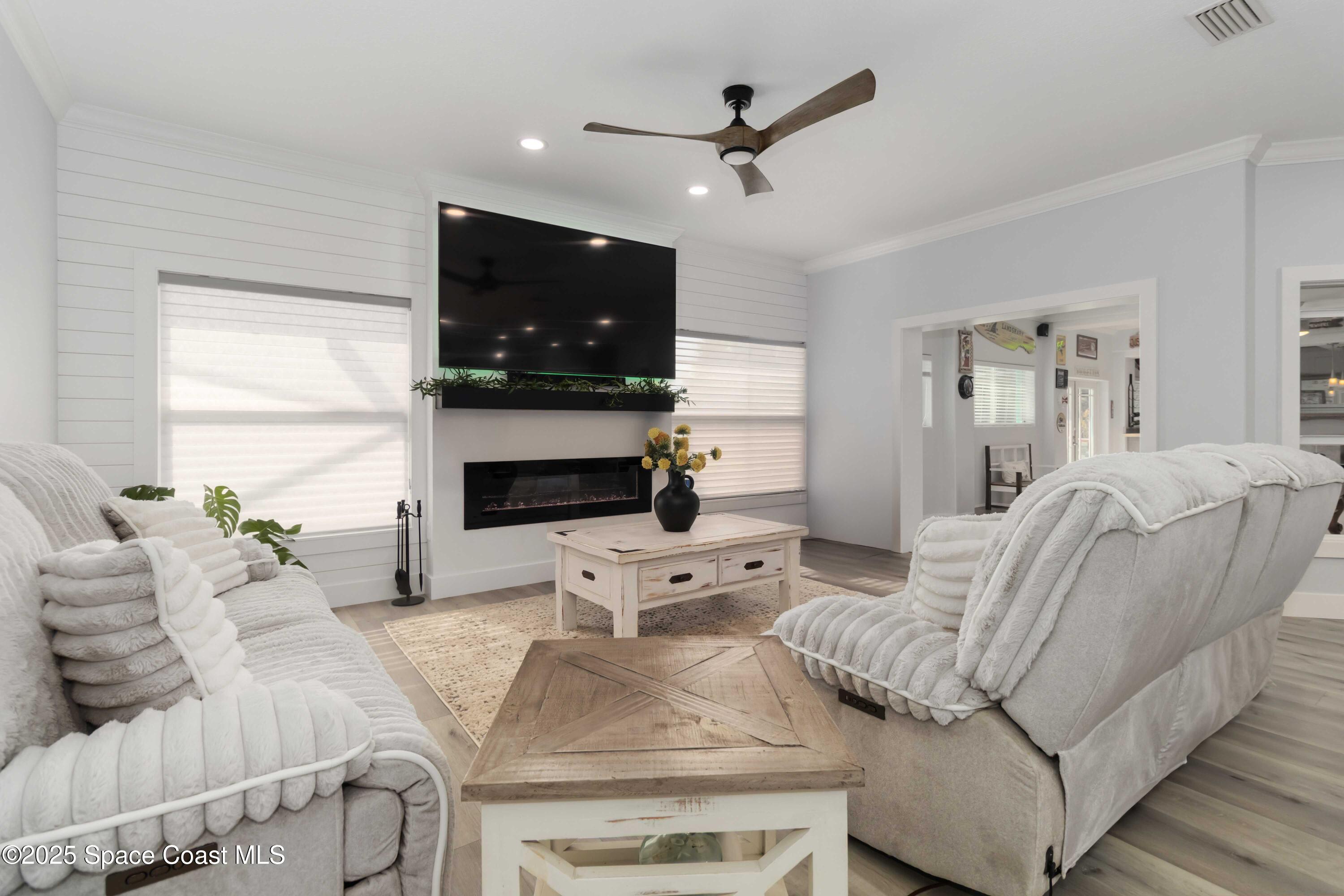 341 Buckskin Street Palm Bay, FL 32909 - Photo 25 of 69 a living room with furniture a flat screen tv and a fireplace