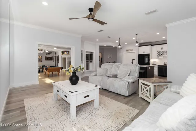 a living room with stainless steel appliances kitchen island granite countertop furniture and a kitchen view