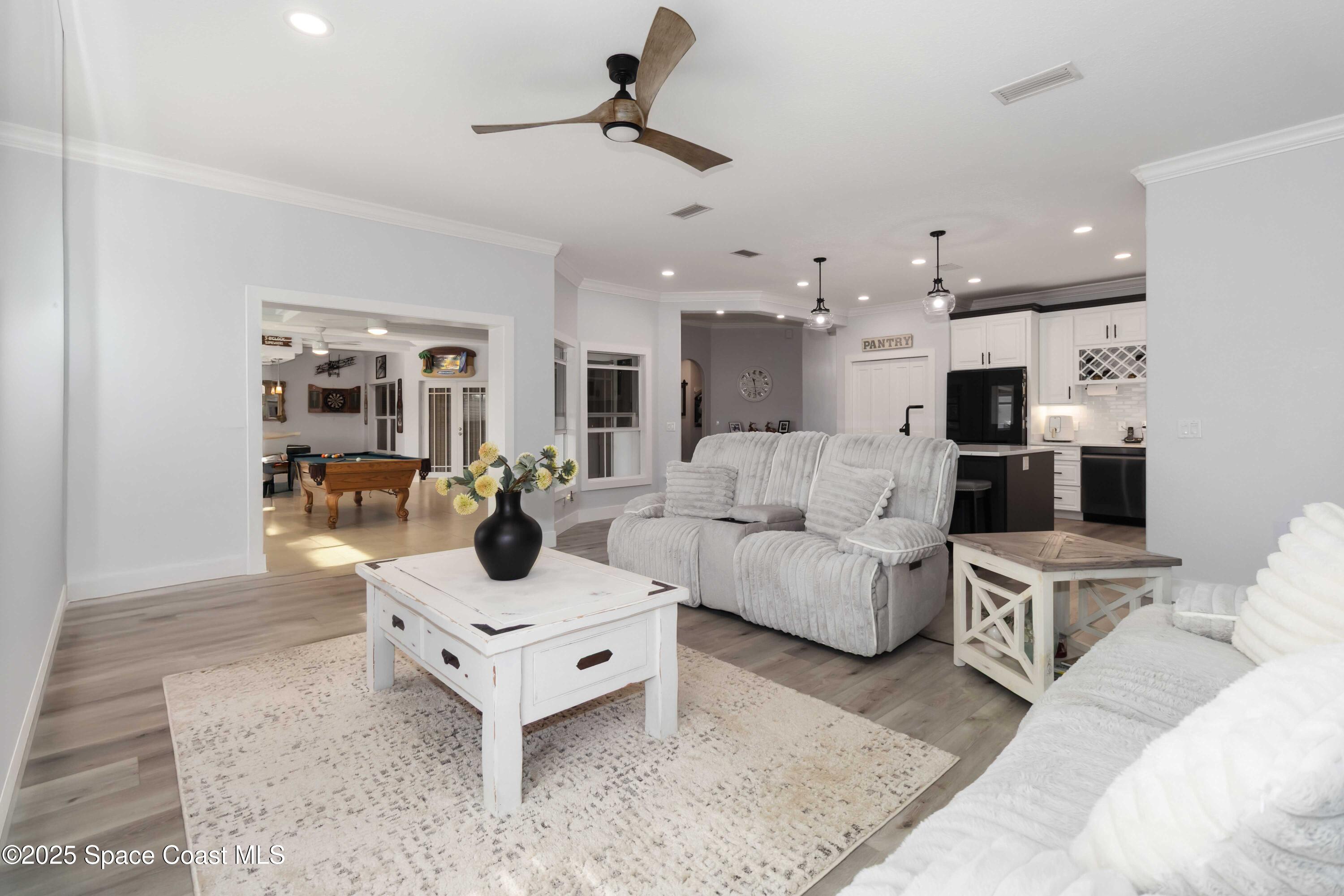 341 Buckskin Street Palm Bay, FL 32909 - Photo 26 of 69 a living room with furniture and kitchen view