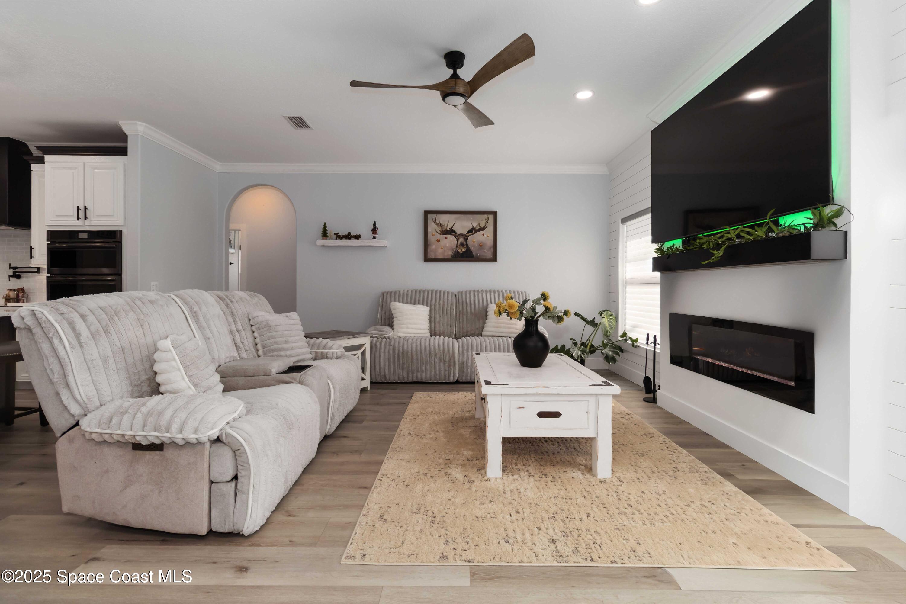 341 Buckskin Street Palm Bay, FL 32909 - Photo 27 of 69 a living room with furniture a flat screen tv and a fireplace