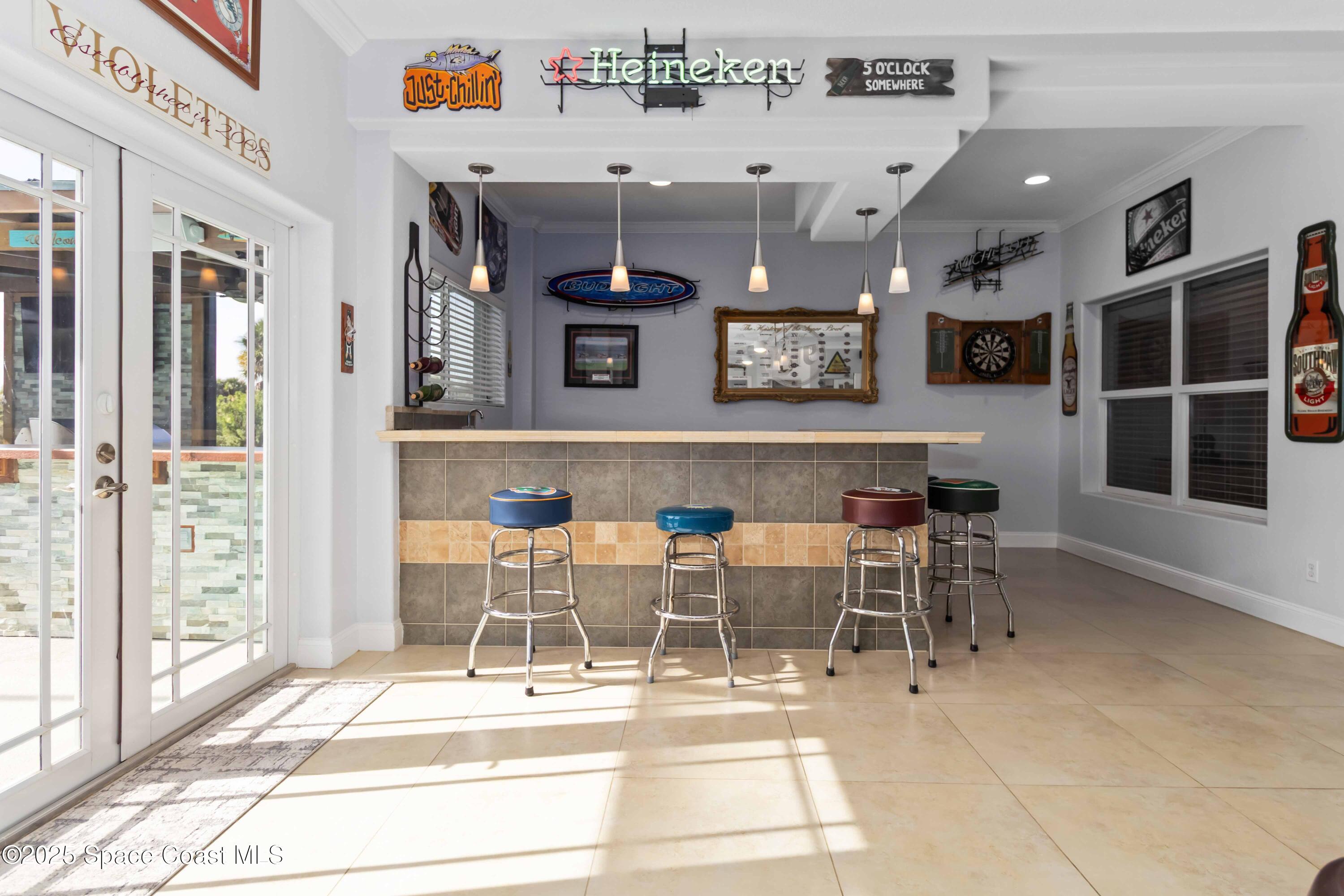 341 Buckskin Street Palm Bay, FL 32909 - Photo 28 of 69 a view of a dining room with furniture and a floor to ceiling window