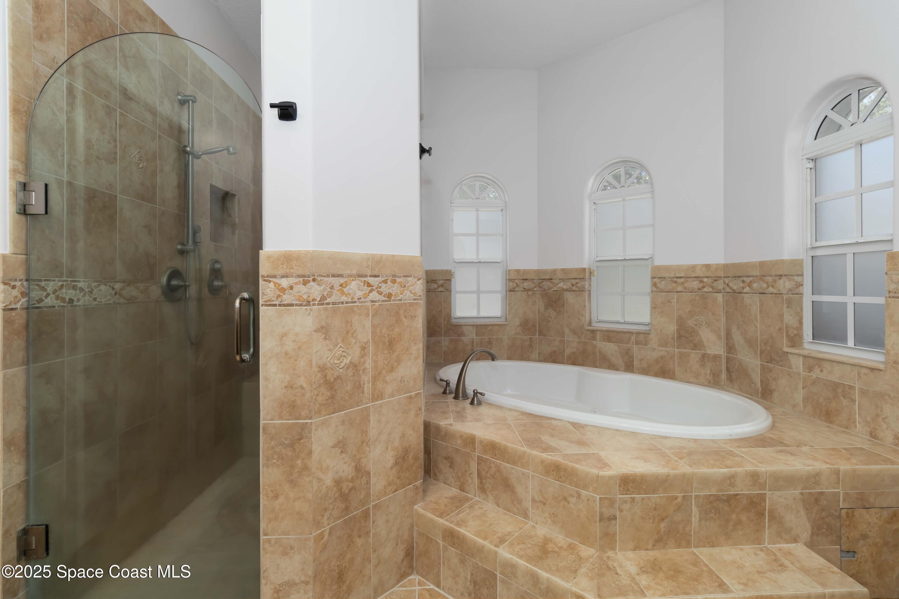 341 Buckskin Street Palm Bay, FL 32909 - Photo 36 of 69 a bathroom with a bathtub and shower