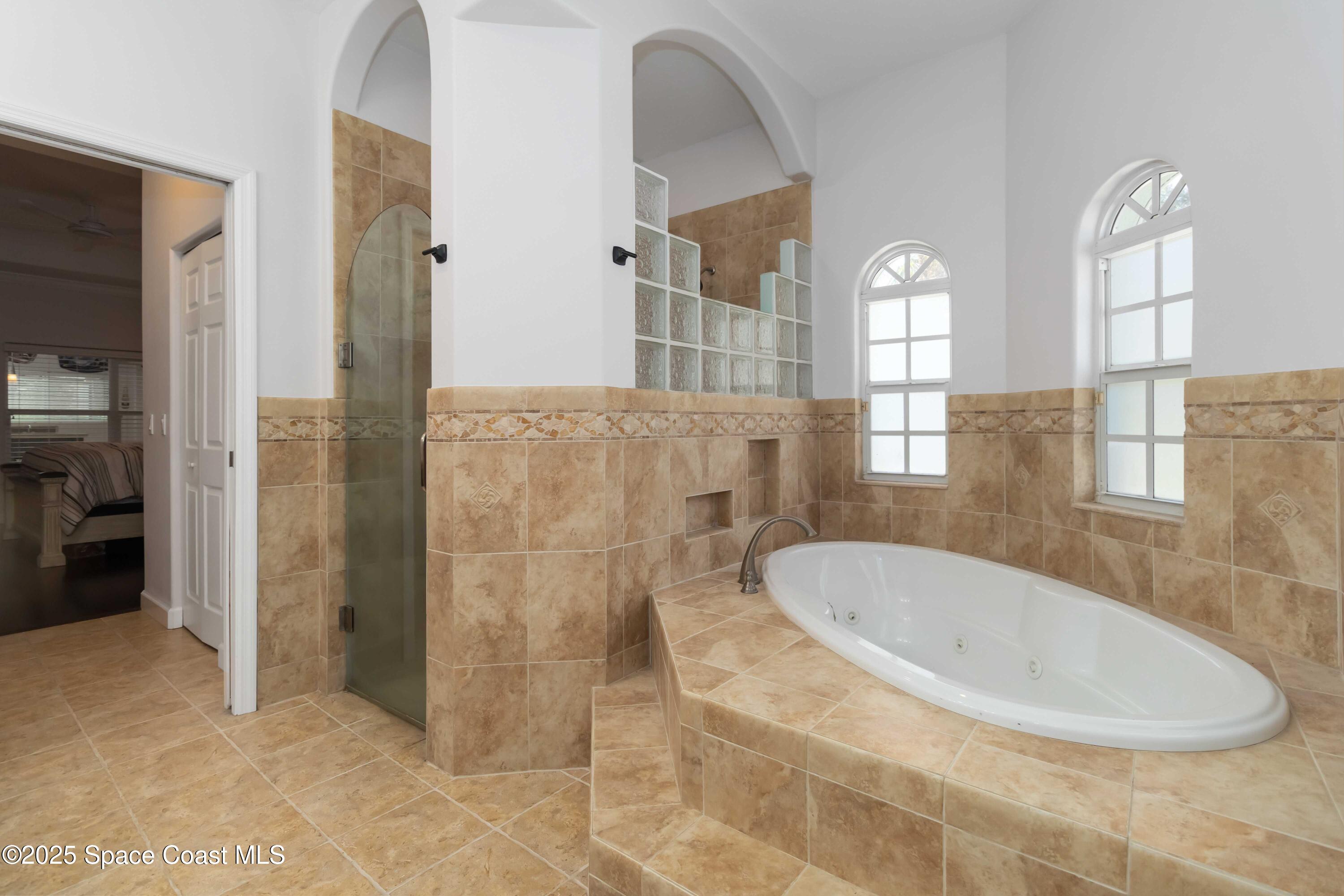 341 Buckskin Street Palm Bay, FL 32909 - Photo 37 of 69 a bathroom with a granite countertop sink a mirror and shower