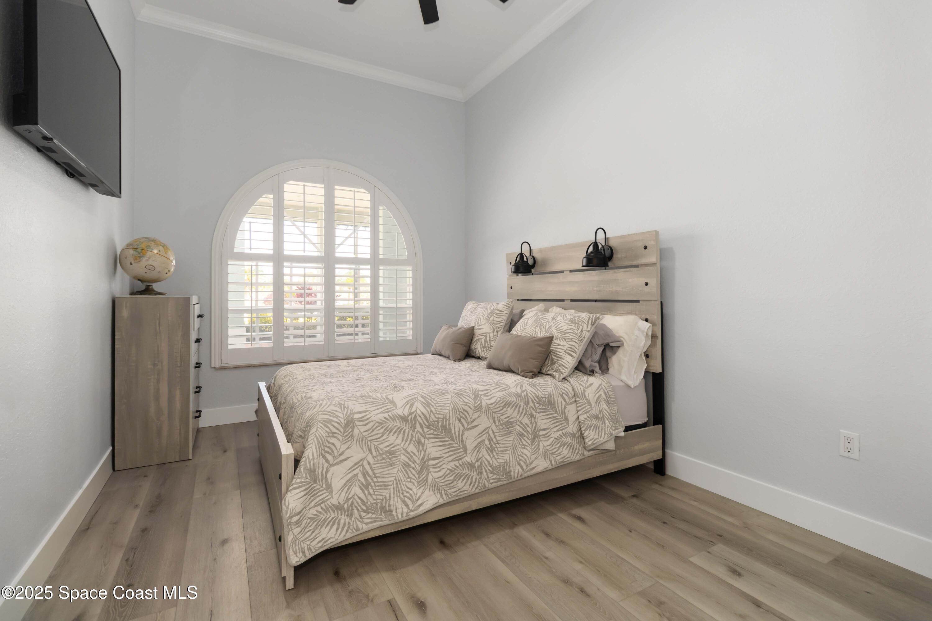 341 Buckskin Street Palm Bay, FL 32909 - Photo 39 of 69 a bedroom with a bed and a flat tv screen on dresser