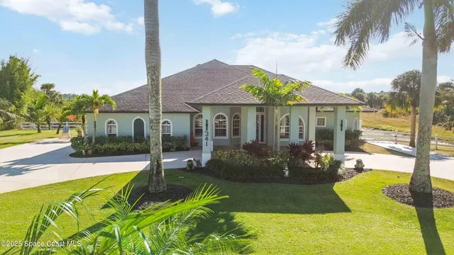 a view of a house with swimming pool and sitting area
