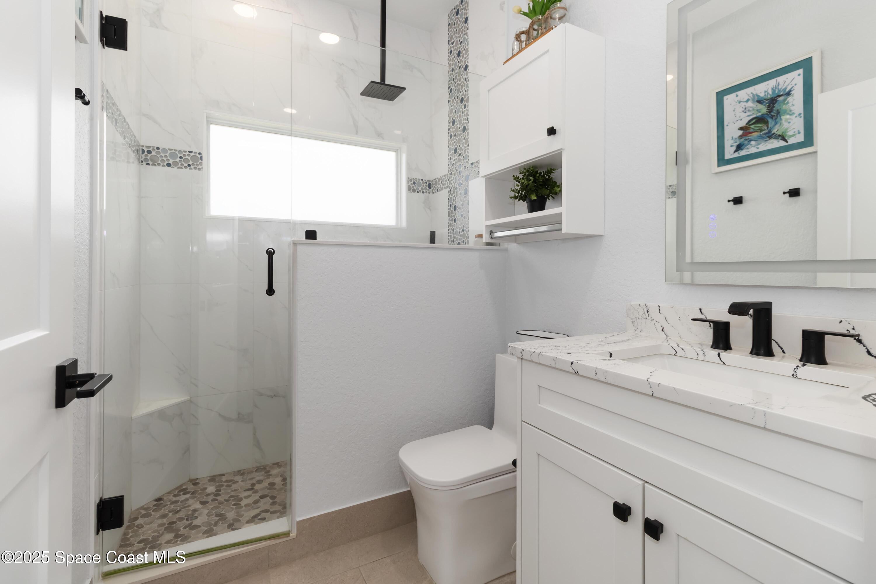 341 Buckskin Street Palm Bay, FL 32909 - Photo 41 of 69 a bathroom with a granite countertop sink a toilet and a mirror