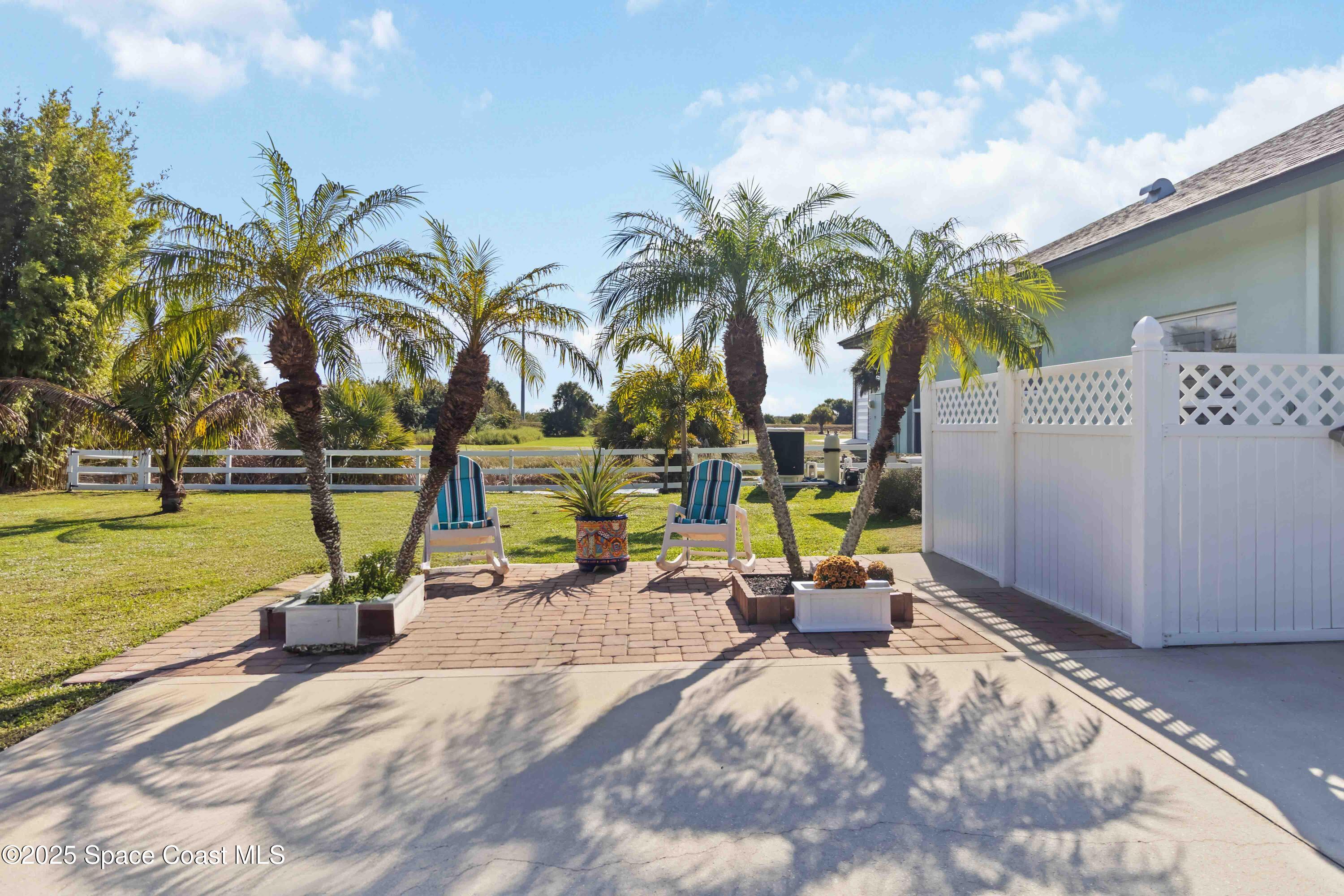 341 Buckskin Street Palm Bay, FL 32909 - Photo 48 of 69 a view of a swimming pool with a table and chairs