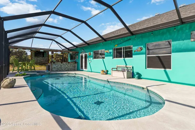 a view of a swimming pool with an outdoor seating