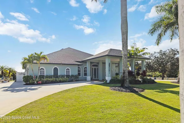 a front view of a house with garden