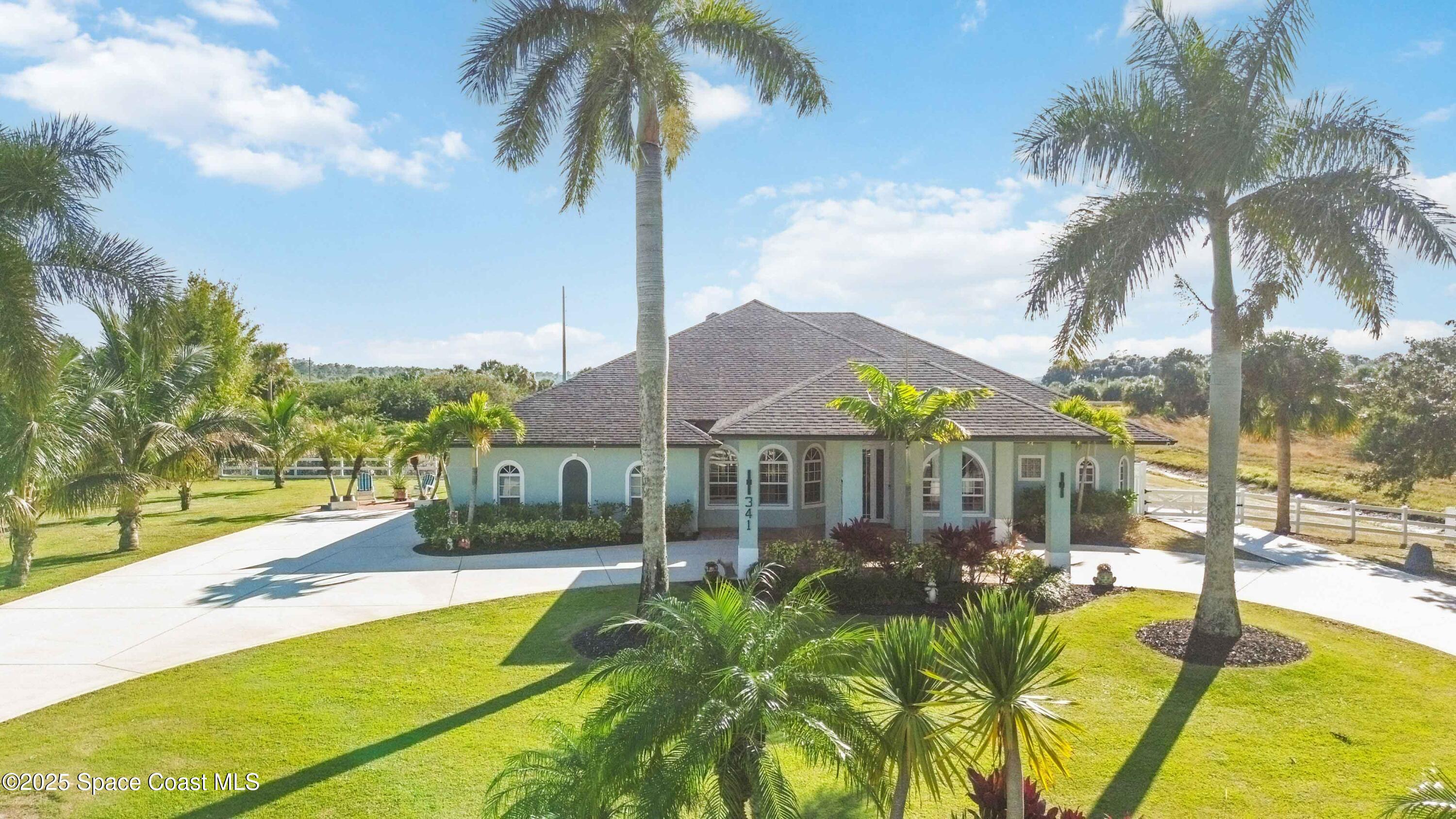 341 Buckskin Street Palm Bay, FL 32909 - Photo 10 of 69 a view of a swimming pool with a garden