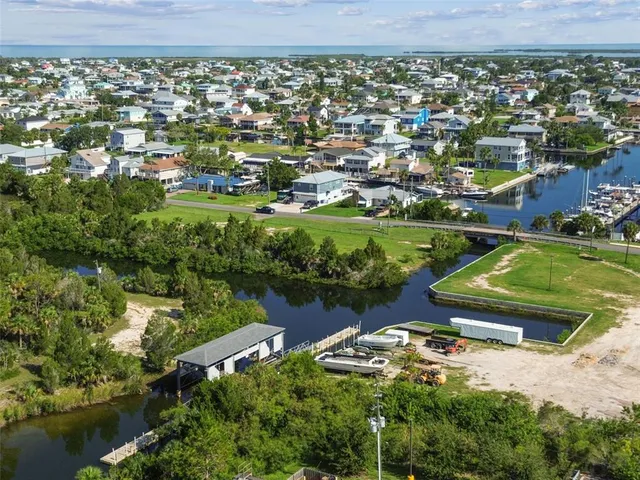 an aerial view of residential houses with outdoor space and lake view