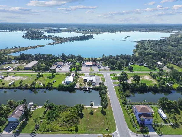 a backyard of a house with lots of green space and lake view