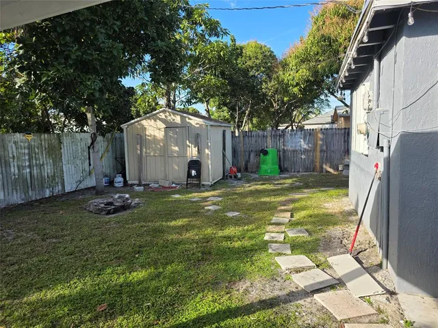 a view of a backyard with large tree