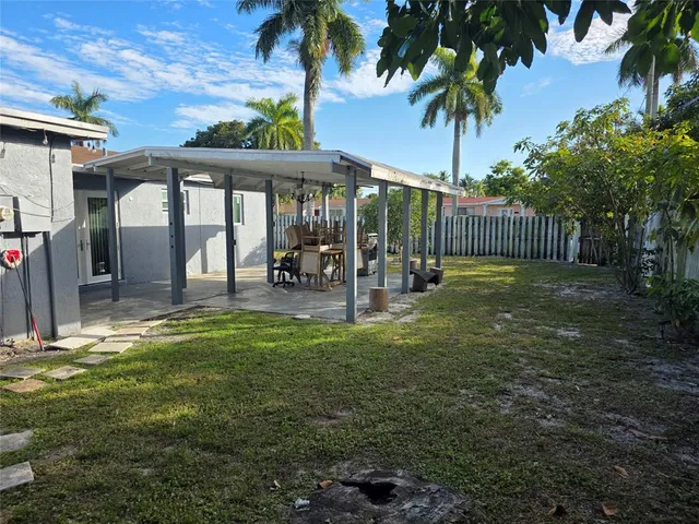 a backyard of a house with table and chairs